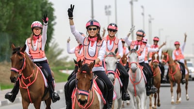 V for victory: the 15 horse riders start out on the annual Pink Caravan Ride to raise awareness about breast cancer. Victor Besa for The National