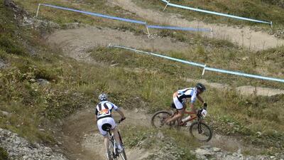 Cyclists in action during the first stage of the Swiss Epic Race on Monday. Maxime Schmid / EPA