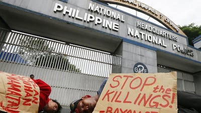 Protesters stage a “die-in” to dramatise the rising number of extra judicial killings related to Philippine president Rodrigo Duterte’s War on Drugs outside the Philippine National Police headquarters in Quezon City north-east of Manila, Philippines. Bullit Marquez / AP Photo