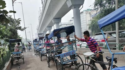 Rickshaw pullers wait for passengers outside a metro station in New Delhi as air quality continues to remain in hazardous category. Taniya Dutta for The National