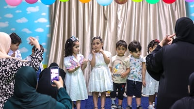 Young pupils perform a song in front of their loved ones