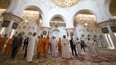 Mahant Swami Maharaj is guided through the prayer hall of the Grand Mosque by Sheikh Nahyan and Dr Yousif Alobaidli.