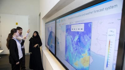 From left: Dr Imen Gherboudj, Luis Calisto and Dr Naseema Beegum watch real-time forecasts of dust movement on a system developed at Abu Dhabi’s Masdar Institute. Christopher Pike / The National