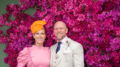 Zara Tindall, wearing a light pink silk Rebecca Vallance dress with an orange pewter headpiece by Millinery Jill and a Kate Spade bag, and Mike Tindall attend the Magic Millions Raceday at the Gold Coast Turf Club on January 11, 2020. Getty Images