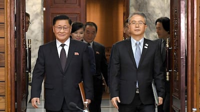 The head of South Korean delegation Lee Woo-sung, right, and the head of North Korean delegation Kwon Hook Bong, left, arrive for their meeting at the North side of Panmunjom in North Korea on January 15, 2018. Officials from the Koreas met Monday to work out details about North Korea's plan to send an art troupe to the South during next month's Winter Olympics. South Korea Unification Ministry via AP