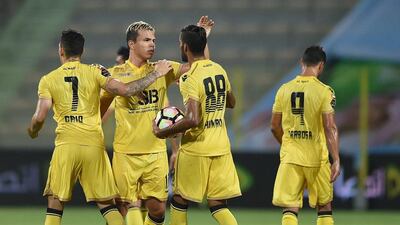 Fabio de Lima, second left, celebrates after scoring Al Wasl's equalising goal against Al Dhafra. Tom Dulat / Getty Images