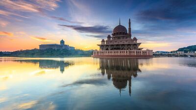 Masjid Putra, on the edge of Putrajaya Lake, is more traditional in style. Getty