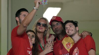 Pakistani director and bowling coach of Islamabad United Wasim Akram, secod right, and his wife Shaniera Akram, third left, take a group selfie. Aamir Qureshi / AFP