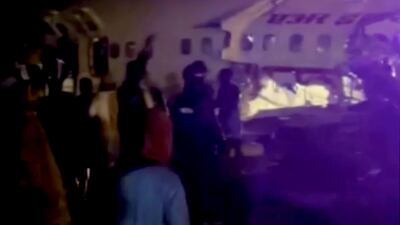 Images from India's ANI news agency show a damaged Air India Express plane that crashed close to the runway at Kozhikode International Airport. ANI / Reuters