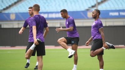 Raheem Sterling, right, stretches during training. Getty