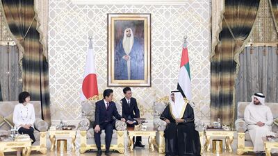 Japanese PM Shinzo Abe (second left) talks with Dr Sultan Al Jaber (second right), upon his arrival to visit Abu Dhabi on first leg of his Middle East tour. EPA / WAM