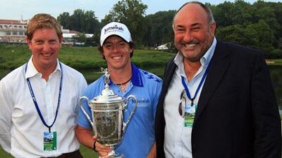 Rory McIlroy of Northern Ireland, standing with Stuart Cage, left, and his then agent Andrew 'Chubby' Chandler after winning the US Open. McIlroy fired Chandler recently but wants to 'remain friends' with him.