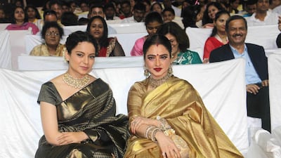 Kangana Ranaut looks chic in dark green, but the major fashion moment here is Rekha in a striking gold Kanjeevaram saree. No one does a red lip and a beautiful saree quite like Rekha. AFP
