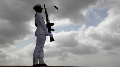 A bird flies past a cadet of the Pakistan Navy, as he is seen during a ceremony to celebrate the country's 70th Independence Day at the mausoleum of Muhammad Ali Jinnah in Karachi, Pakistan August 14, 2017. REUTERS/Akhtar Soomro