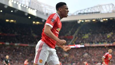 Manchester United’s French striker Anthony Martial celebrates after scoring their first goal during the English FA Cup quarter final football match between Manchester United and West Ham United at Old Trafford in Manchester, north-west England, on March 13, 2016. The game finished 1-1. AFP / PAUL ELLIS