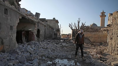 A Syrian man walks amid the rubble of a building following reported air strikes by regime forces on the village of Kityan in Syria's northwestern Idlib province. AFP
