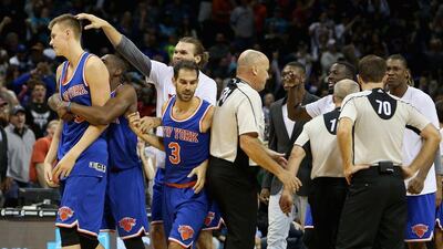 Kristaps Porzingis, left, of the New York Knicks celebrates with teammates after a shot at the end of the game which was overturned giving the Charlotte Hornets a 95-93 victory at Time Warner Cable Arena on November 11, 2015 in Charlotte, North Carolina. Streeter Lecka/Getty Images/AFP