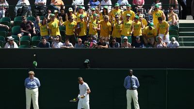 Australian fans cheer Lleyton Hewitt during his first round loss to Jarkko Nieminen on Monday at the opening day of Wimbledon at the All England Club. Carl Court / Getty Images