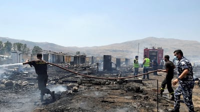 Firefighters put out a fire at a camp for Syrian refugees near the town of Qab Elias in Lebanon's Bekaa Valley. Hassan Abdallah / Reuters