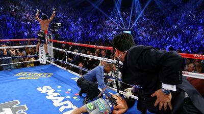 Marquez celebrates as Manny lays face down on the mat after being knocked out in the sixth round. Al Bello / Getty Images