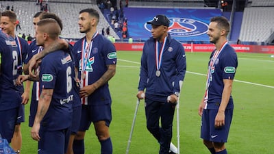 Kylian Mbappe walks with crutches. AFP