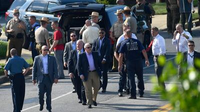 Maryland Gov. Larry Hogan, center in sunglasses, surveys the scene of a shooting in Annapolis, Md., Thursday, June 28, 2018. (AP Photo/Susan Walsh)
