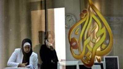 Employees of the Arab news station Al Jazeera pack equipment and talk on the phone at the station's offices in the West Bank city of Ramallah.