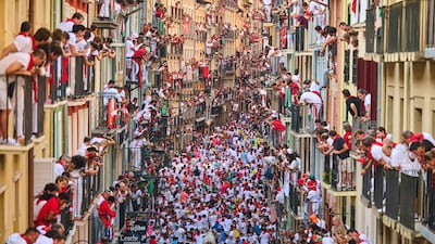 Revellers attend the sixth running of the bulls at the San Fermin Festival in Pamplona, Spain. AP Photo