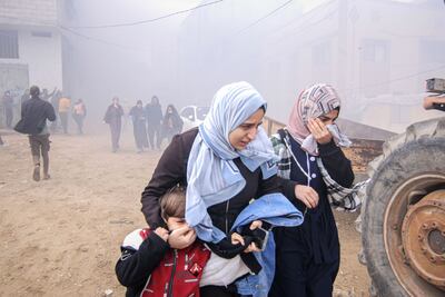 Palestinian families run from the site of an Israeli airstrike on a residential building west of the Nasser Medical Hospital in Khan Younis, southern Gaza, on Thursday, Jan. 11, 2024. Bloomberg