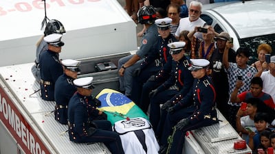 The casket of Brazilian legend Pele is taken through the streets of Santos during his funeral ceremony on Tuesday. Reuters