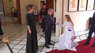 Britain's Princess Beatrice, in a sequined Needle & Thread gown and Sophia Webster clutch, greets the Jordanian king and queen