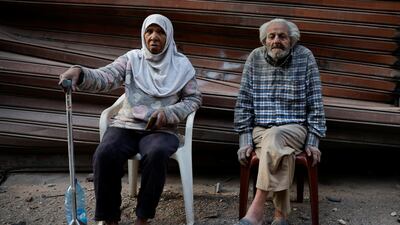 Elderly people near the site of the Israeli strike in Basta. Reuters