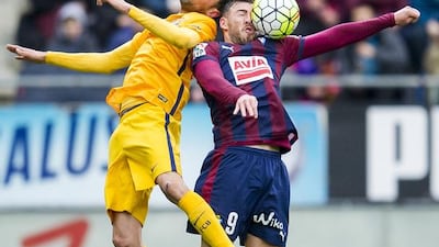 SD Eibar’s Sergi Enrich competes for the ball with Barcelona’s Sergio Busquets during their Primera Liga match. Juan Manuel Serrano Arce / Getty Images