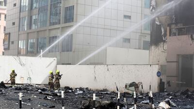 Dubai Civil Defence personnel try to quell the fire.