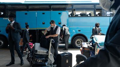 Sean Williams, centre, loads his cricket bag at the Robert Mugabe International Airport in Harare. AFP