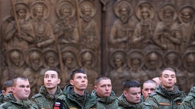 Russian soldiers attend a service during the military campaign in Ukraine. Reuters