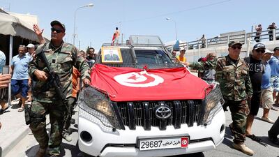 Police officers walk in front of the coffin of Anis El Werghi, a Tunisian security forces member who was killed in an ambush in the northwest of the country. Reuters