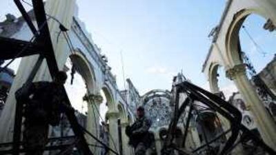 US army personnel check for a signal inside the devastated Grand Cathedral in Port-au-Prince.