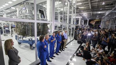 Gwynne Shotwell, president and chief operating officer of SpaceX, and NASA astronauts Bob Behnken, Doug Hurley, Mike Hopkins, and Victor Glover, stand in front of the Crew Dragon spacecraft clean room. Bloomberg