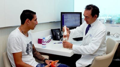 Angel Di Maria, left, undergoes his medical at a hospital in Doha, Qatar ahead of his move to Paris Saint-Germain. Aspetar Hospital / AFP