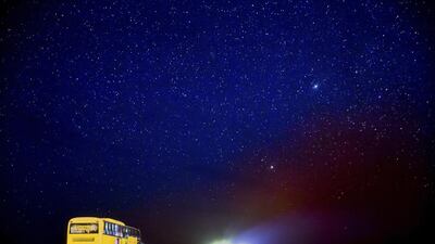 A tourist bus parks in the Khour salt lake as Iranians warm themselves around a fire, while watching stars, in a tour of the Mesr desert about 305 miles southeast of the capital Tehran, Iran. Ebrahim Noroozi / AP Photo