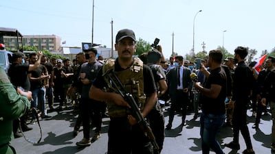 Members of Iran-backed militia groups march in central Baghdad, Iraq. AP