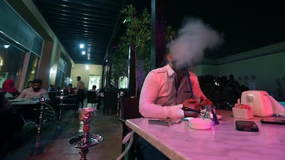 People smoking shisha at a restaurant in Dubai. Satish Kumar / The National