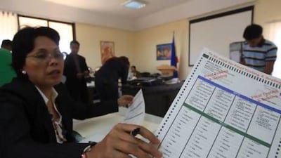 Grace Princesa, the Philippine ambassador to the UAE, checks a sample ballot at the Philippine Embassy yesterday. Ravindranath K / The National