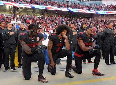 NFL protests against police brutality began in 2016 after former San Francisco 49ers quarterback Colin Kaepernick (centre) sat during the anthem. Kirby Lee/USA Today Sports