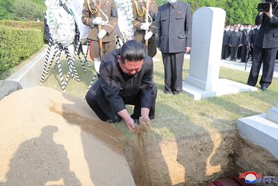 Kim Jong-un covers the coffin of Marshal of the Korean People's Army Hyon Chol-hae with earth at a cemetery in Pyongyang. Korean Central News Agency/AP
