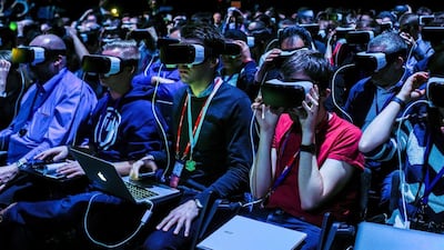Visitors test out the VR headsets which connect to the S7. David Ramos / Getty Images