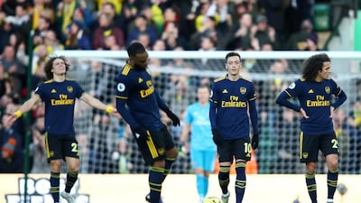 Mesut Ozil and teammates walk back to the half way line during the Premier League match against Norwich at Carrow Road. Getty
