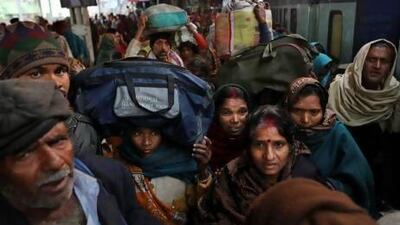 Indians crowd on a train on platform six near where a stampede took place a night before, at the station in Allahabad.