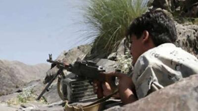 An Afghan police man guards the hilltop in Bodyalai village of Khiva district, in Nangarhar province, east of Kabul, Afghanistan, on Aug 27, 2008.